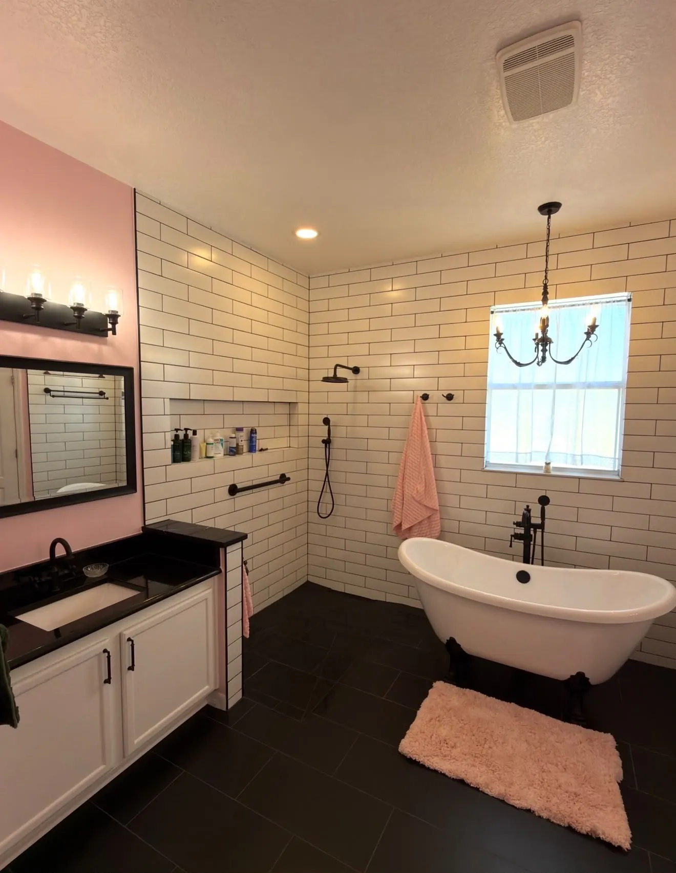 Remodeled primary bathroom with freestanding tub, subway tile and slate floor