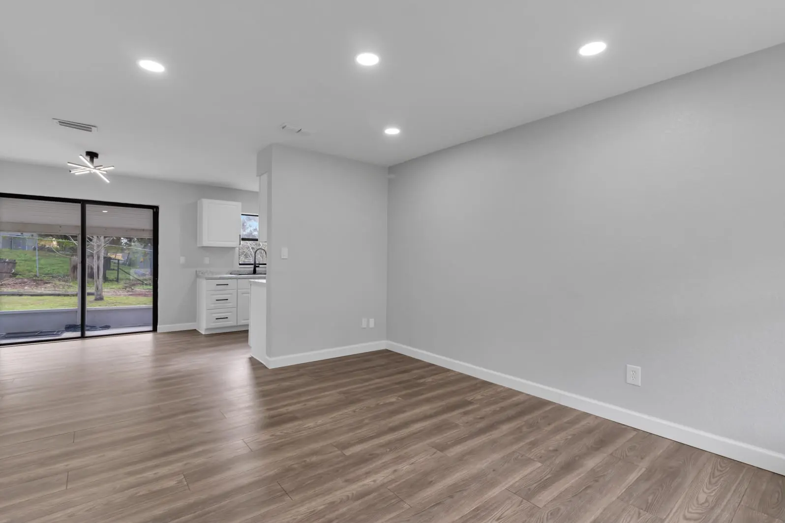 Bright open living area after remodeling, with luxury vinyl plank flooring