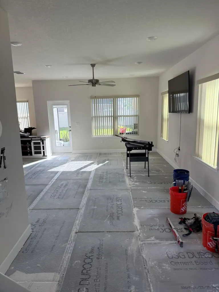 Cement board underlayment installed across a floor before tiling