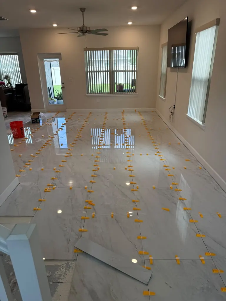 Large-format porcelain tile being set with levelling clips